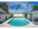Beautiful backyard pool with lounge chairs, palm trees, and well-maintained landscaping at 1800 W Shawnee Dr, Chandler, AZ 85224
