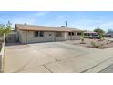 Exterior view of a single-story home featuring a spacious driveway at 2030 E Alder Cir, Mesa, AZ 85204