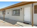 View of front porch with a white door, window and neutral siding at 2030 E Alder Cir, Mesa, AZ 85204