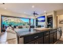 Modern kitchen with dark cabinetry, granite counters, stainless appliances, and mountain views through large windows at 27000 N Alma School Pkwy # 1033, Scottsdale, AZ 85262