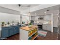 Charming updated kitchen featuring grey cabinets, modern appliances, an island and stylish decor at 3222 E Cortez St, Phoenix, AZ 85028