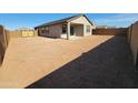 Spacious backyard with covered patio, block fence, and blank canvas ready for your dream landscape design at 328 S San Christo Ln, Casa Grande, AZ 85194