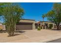 Single story home featuring a desert landscape, a two car garage and mature desert trees at 3512 S Elm St, Tempe, AZ 85282