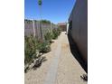 Charming side yard featuring a gravel path and a colorful flower garden along the side of the house at 3512 S Elm St, Tempe, AZ 85282