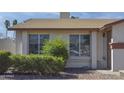 Exterior shot of a cozy home featuring well-placed windows and mature shrubs at 3519 W Libby St, Glendale, AZ 85308