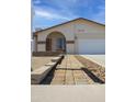 Well-maintained front yard and walkway lead to the entrance of this inviting single-story home at 3519 W Libby St, Glendale, AZ 85308