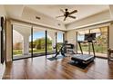 Bright exercise room with wood floors, ceiling fan, and sliding glass doors that open to the beautiful outdoors at 4366 S Avenida De Angeles --, Gold Canyon, AZ 85118