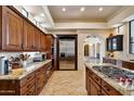 Spacious kitchen with stainless steel appliances, granite countertops, tile flooring, and wood cabinetry at 4366 S Avenida De Angeles --, Gold Canyon, AZ 85118