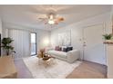 Bright living room featuring a modern sofa, stylish coffee table, and a ceiling fan at 5757 W Eugie Ave # 2068, Glendale, AZ 85304