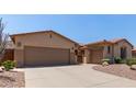Lovely home showcasing a spacious driveway, two-car garage, and low-maintenance desert landscaping at 5919 W Straight Arrow Ln, Phoenix, AZ 85083