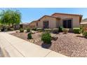 Well-manicured front yard with desert landscaping complements this inviting home at 5919 W Straight Arrow Ln, Phoenix, AZ 85083