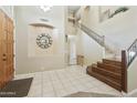 Bright and airy entryway features tile flooring and a staircase leading to the upper level at 5957 W Robin Ln, Glendale, AZ 85310