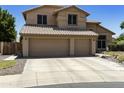 Inviting two-story home features a three-car garage and tile roof at 5957 W Robin Ln, Glendale, AZ 85310