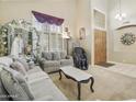 Comfortable living room with neutral carpet, elegant sofas, and natural light at 5957 W Robin Ln, Glendale, AZ 85310