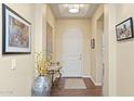 Inviting foyer with hardwood floors and decorative table with flower arrangement at 6231 E Mark Way # 14, Cave Creek, AZ 85331