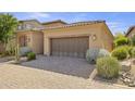 Two-car garage with a brick driveway and well-manicured landscaping surrounding it at 6231 E Mark Way # 14, Cave Creek, AZ 85331