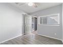 Clean bedroom with gray walls, vinyl floors, a door to outside, and a window at 7132 N 63Rd Dr, Glendale, AZ 85301
