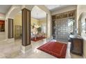 Grand foyer featuring high ceilings, an elegant front door, and seamless transition to the formal dining area at 7335 E Quail Track Rd, Scottsdale, AZ 85266