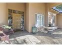 Inviting front porch with fountain and unique door, with covered entry offering privacy and charm at 7335 E Quail Track Rd, Scottsdale, AZ 85266