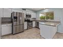 Updated kitchen featuring stainless steel appliances, granite countertops, and tile flooring at 820 W Hononegh Dr, Phoenix, AZ 85027
