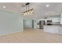 Open-concept kitchen with stainless steel appliances and a spacious dining area at 820 W Hononegh Dr, Phoenix, AZ 85027
