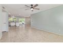 Bright living room with tile flooring, leading into a modern kitchen with sliding glass doors at 820 W Hononegh Dr, Phoenix, AZ 85027
