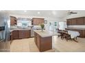 Spacious kitchen featuring an island, tile flooring, and ample cabinet space at 8343 W Calle Lejos --, Peoria, AZ 85383