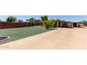 Exterior of the residence with a well-kept lawn, driveway, and mature landscaping at 8632 E Delilah Ave, Mesa, AZ 85208