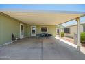 Covered carport offering shade and storage with access doors on both sides at 9822 E Main St # 4, Mesa, AZ 85207