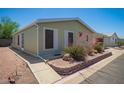 Charming single-story home showcasing desert landscaping and mature bushes at 9822 E Main St # 4, Mesa, AZ 85207