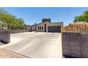 Street view of modern home featuring a contemporary design, gray garage door, and a basketball hoop in the driveway at 1005 E Weldon Ave, Phoenix, AZ 85014