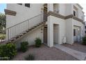 Exterior view of building with outdoor stairs, and two units, showing landscaping and neutral color scheme at 11375 E Sahuaro Dr # 1053, Scottsdale, AZ 85259