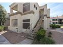 Exterior view of building, showing outdoor stairs, neutral color scheme, and well-maintained landscaping at 11375 E Sahuaro Dr # 1053, Scottsdale, AZ 85259