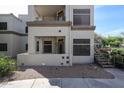 Exterior view of building featuring a covered patio, with access to the unit, landscaping, and outdoor stairs at 11375 E Sahuaro Dr # 1053, Scottsdale, AZ 85259