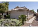 Attractive single story home featuring a two car garage, tile roof, and landscaped front yard at 12044 S 45Th St, Phoenix, AZ 85044