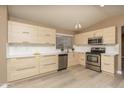 Modern kitchen features stainless steel appliances, sleek cabinets, white countertops and vinyl flooring at 12044 S 45Th St, Phoenix, AZ 85044
