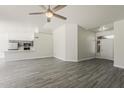 Open concept living area with ceiling fan and modern gray wood-look flooring at 15360 N 87Th Ave, Peoria, AZ 85381