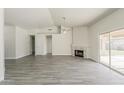 Spacious living room featuring tile floors, ceiling fan, and fireplace at 15360 N 87Th Ave, Peoria, AZ 85381