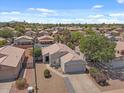 Panoramic aerial view of a residential neighborhood featuring well-kept homes, mature trees, and desert landscaping at 1703 E Palo Blanco Way, Gilbert, AZ 85296
