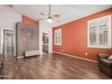 Spacious main bedroom with custom clock art and ensuite bathroom at 18080 W Spencer Dr, Surprise, AZ 85374