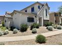 Well-manicured front yard with stone landscaping complements this charming two-story home at 2539 N 148Th Dr, Goodyear, AZ 85395