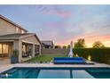 Expansive backyard with a sparkling pool, lounge area, and lush green lawn, perfect for outdoor living at 2854 E Virginia St, Mesa, AZ 85213