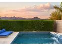 Inviting pool surrounded by lush greenery and lounge seating, set against a scenic mountain view at 2854 E Virginia St, Mesa, AZ 85213
