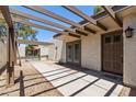 Inviting front entry with a pergola, desert landscaping, and a secure gate for added privacy and charm at 347 Leisure World --, Mesa, AZ 85206