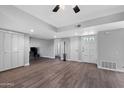 Bright living area featuring wood-look flooring, neutral walls, a ceiling fan, and plenty of closet space at 347 Leisure World --, Mesa, AZ 85206
