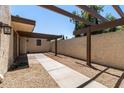 This patio showcases a pergola, desert landscaping, and a concrete walkway, perfect for outdoor living at 347 Leisure World --, Mesa, AZ 85206