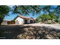 Side view of a three-car garage with terracotta tile roof, and desert landscaping at 35 E Secretariat Dr, Tempe, AZ 85284