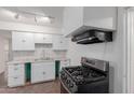Updated kitchen featuring stainless steel appliances, white cabinets, and modern countertops at 3622 W Sunland Ave, Phoenix, AZ 85041