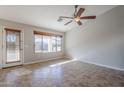 Light-filled living room with a ceiling fan, tile floors, and access to the backyard at 3649 E Hazeltine Way, Chandler, AZ 85249