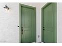 View of the front doors with hardware and outdoor lighting at 37727 W Padilla St, Maricopa, AZ 85138